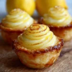 Baby Lemon Impossible Pies with a golden crust and creamy lemon filling.