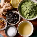 Fresh ginger, lemon slices, matcha powder, dried tea leaves, and honeycomb on a wooden tray, ingredients for making Japanese Mounjaro recipe