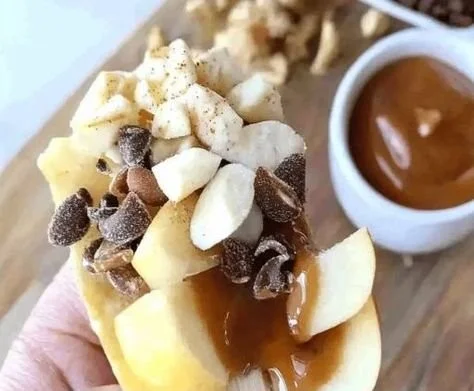 Delicious caramel apple nachos topped with chocolate and nuts