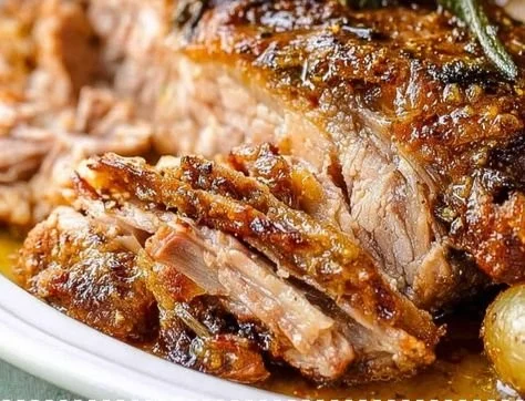 Delicious crockpot pork roast ready to serve with vegetables.