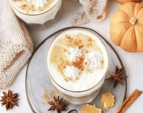 Easy Pumpkin Spice Milk recipe in a cup topped with whipped cream and spices.