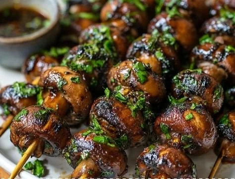 Marinated grilled mushroom skewers on a barbecue grill.
