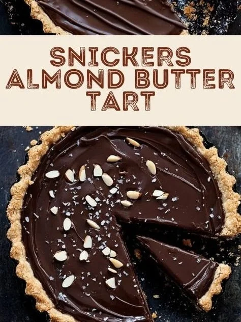 Delicious Snickers Almond Butter Tart topped with nuts and chocolate.