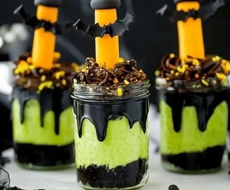 Witches' Brew Halloween Cake Jars with spooky decorations and vibrant layers